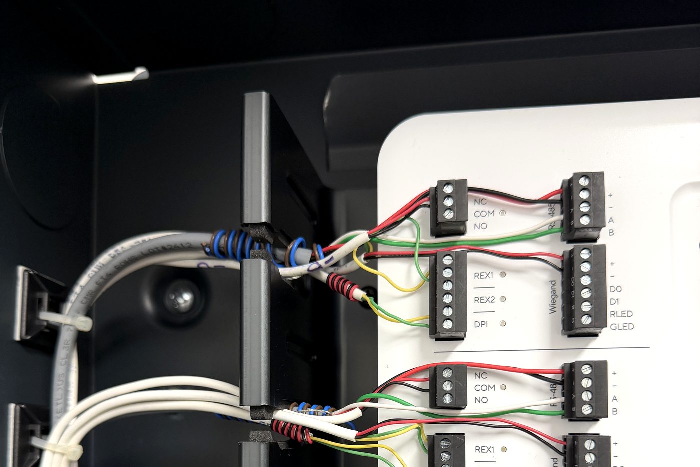 Verkada access control panel with each door cable dressed to the rail, labeled and terminated